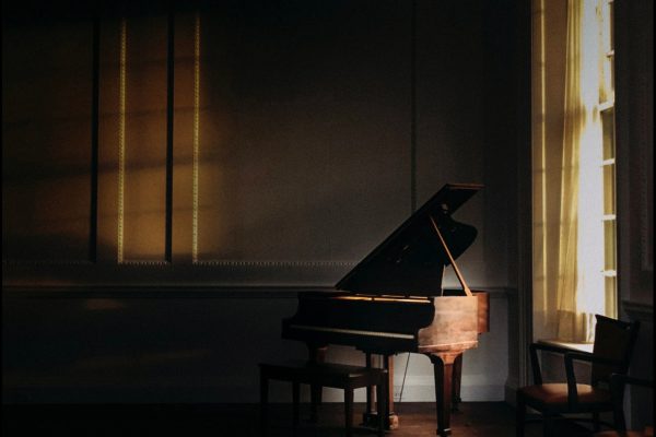 Window light over a grand piano